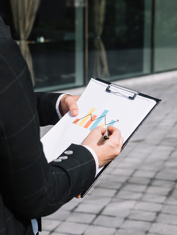 close-up-business-person-s-hand-drawing-increasing-arrow-graph-clipboard 1 What we offter